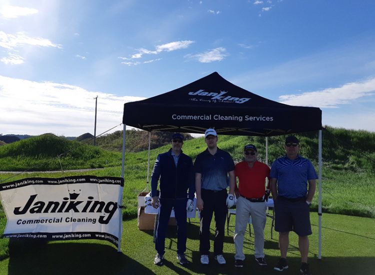 Golfers standing under tent